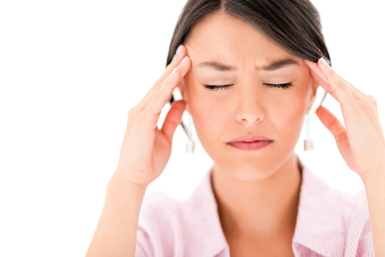 Frustrated woman having a headache - isolated over a white background